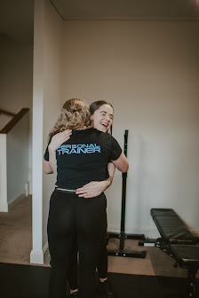 Coach embracing a client after a session